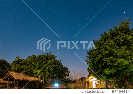 Night view of wooden shacks under the sky 67464414