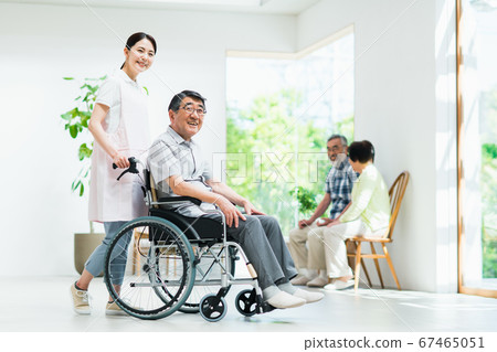 Senior man in wheelchair and nursing staff Senior man in wheelchair and nursing staff 67465051
