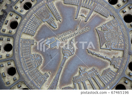 Street manhole cover with the image of landmarks in Berlin 67465196