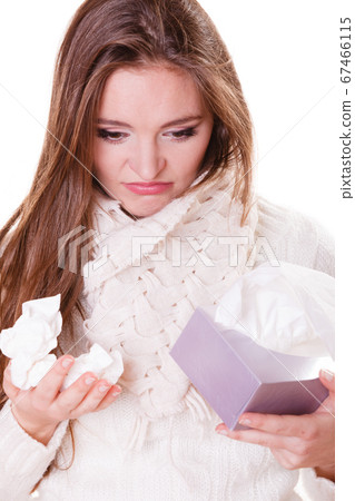 Sick woman girl with fever sneezing in tissue 67466115
