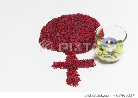 pile of red stones forming the symbol of the woman 67466334