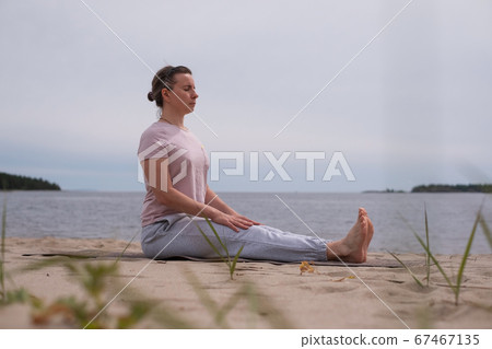 Young sporty woman practicing yoga, doing Dandasana pose Young sporty woman practicing yoga, doing Dandasana pose 67467135