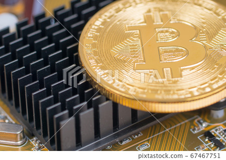 bitcoin metallic coin on chip cooler closeup shot 67467751