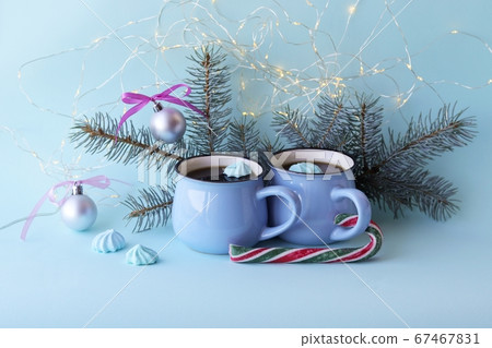 Merry Christmas, two cups of coffee, meringues, festive decor, illumination, mint color background, concept of home comfort Merry Christmas, two cups of coffee, meringues, festive decor, illumination, mint color background, concept of home comfort 67467831