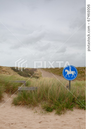 Blue road sign for riders on the beach in De 67468006