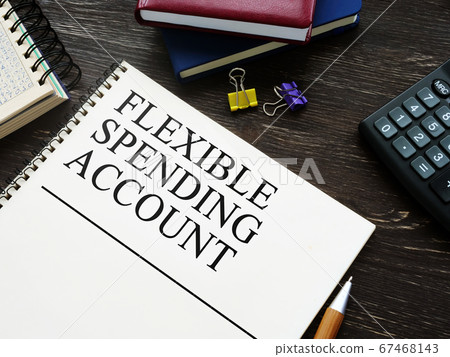Flexible Spending Account FSA and notebooks on wooden surface. Flexible Spending Account FSA and notebooks on wooden surface. 67468143