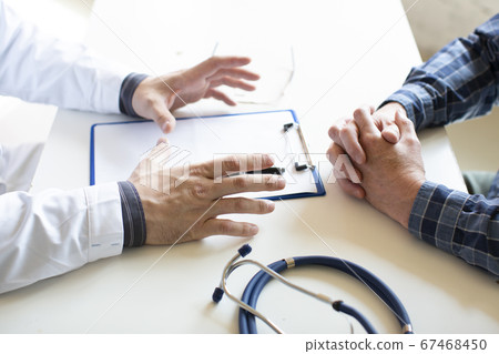 Hands of a doctor and patient close-up. Signing of health insurance documents. Hands of a doctor and patient close-up. Signing of health insurance documents. 67468450