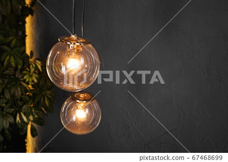 Decorative light tungsten bulbs against wall background 67468699