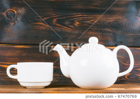 tea cup and pot on rustic wooden table 67470769