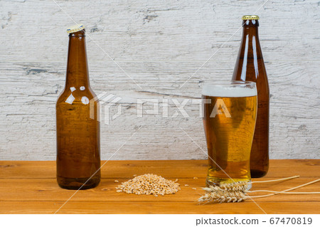 beer in bottles and glass with barley ears and beer in bottles and glass with barley ears and 67470819