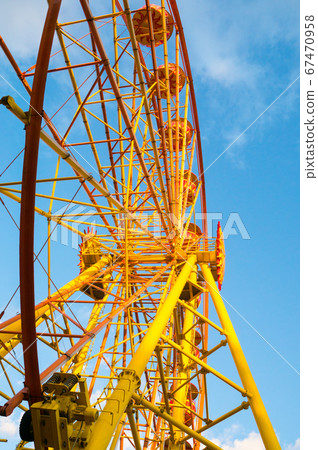 ferris wheel on cloudy sky background 67470958