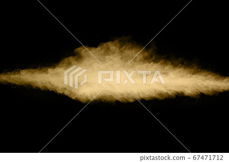 Golden powder explosion on black background. Freeze motion. Golden powder explosion on black background. Freeze motion. 67471712