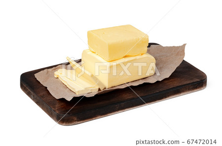 Butter on wooden board isolated on white background 67472014