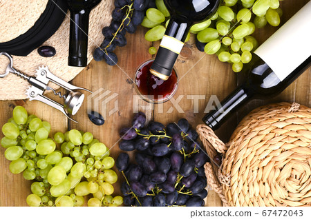 Traditional Italian harvest festival, symbol of summer vacation. On a wooden background Grapes, wine Traditional Italian harvest festival, symbol of summer vacation. On a wooden background Grapes, wine 67472043
