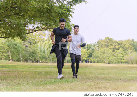 Activity two people running together with tree on Activity two people running together with tree on 67473245