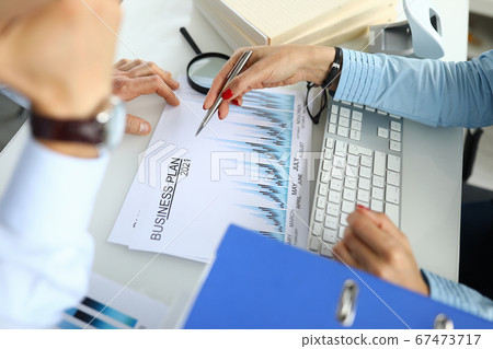 Businessman and businesswoman in office are developing business plan for 2021 Businessman and businesswoman in office are developing business plan for 2021 67473717