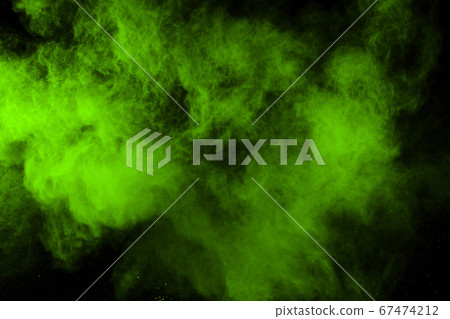 The movement of abstract dust explosion frozen green on black background. Stop the movement of powdered green on black background. Explosive powder green on black background. The movement of abstract dust explosion frozen green on black background. Stop the movement of powdered green on black background. Explosive powder green on black background. 67474212