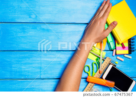 the student does not want to learn and removes school supplies on the desk. student prefers to perform other tasks. Numbering of tasks. to do list. hand sweeps things away. Learning process 67475367