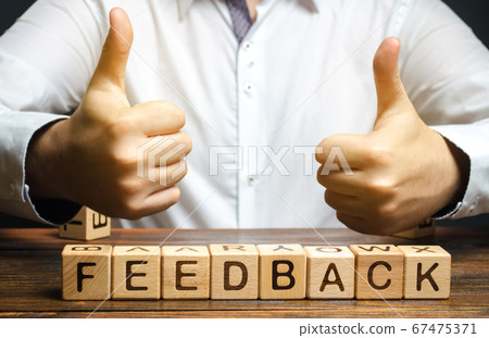 Wooden blocks with the word Feedback and hand up. The concept of the rating of hotels and restaurants. The evaluation of visitors. Quality level, good service. Best customer rating. 67475371