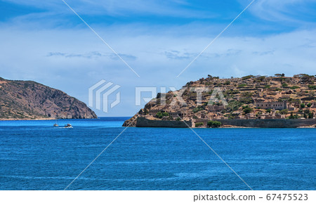 View of west bank of Spinalonga island and Venetian fortress on clear sunny summer day, Crete, Greece 67475523