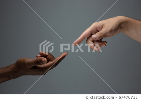Racial tolerance. Respect social unity. African and caucasian hands gesturing isolated on gray studio background 67476713