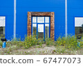 overgrown entrance to an abandoned shopping center building 67477073