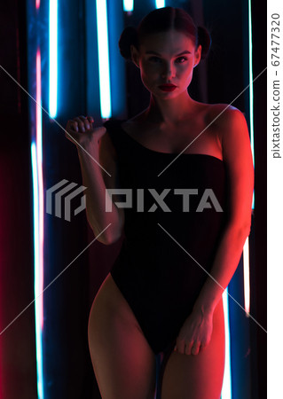 Sensual woman under neon illumination 67477320