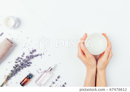 Top view woman's hands holding jar soothing cream Top view woman's hands holding jar soothing cream 67478612