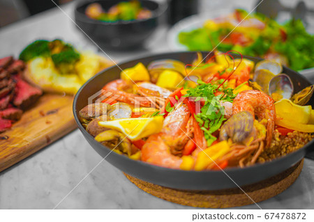 Image of Paella (Spanish food) with lots of ingredients Image of Paella (Spanish food) with lots of ingredients 67478872