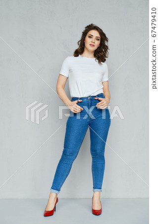 Positive girl in jeans, t-shirt and stilettos 67479410