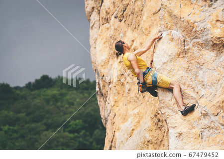 Man climbs a rock. 67479452
