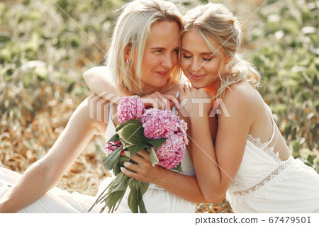 Mother with beautiful daughter in a autumn field 67479501