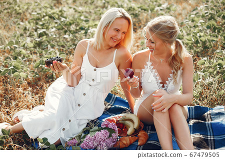 Mother with beautiful daughter in a autumn field 67479505
