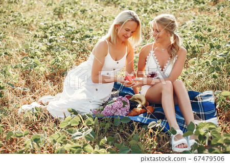 Mother with beautiful daughter in a autumn field 67479506