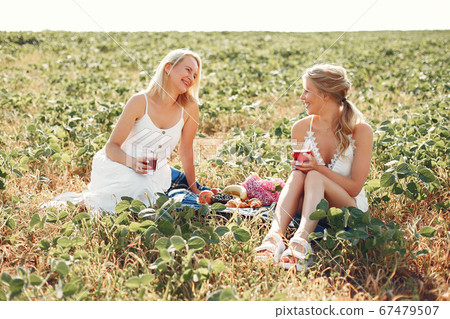 Mother with beautiful daughter in a autumn field Mother with beautiful daughter in a autumn field 67479507