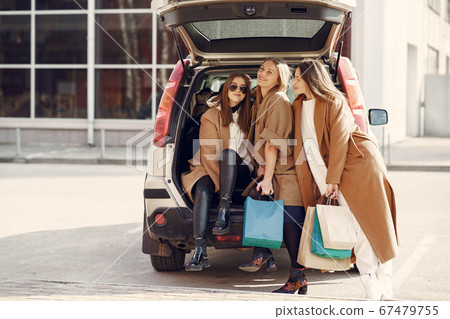 Woman walks outside with shopping bags Woman walks outside with shopping bags 67479755