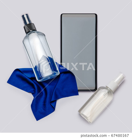 Protection or sanitation against viruses or germs - mobile phone cleaning or disinfection with sanitizer antiseptic spray and cloth 67480167