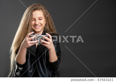 online fun mobile app excited girl watching phone online fun mobile app excited girl watching phone 67481021