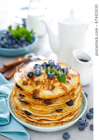 Blueberry pancakes with butter, maple syrup and 67481630