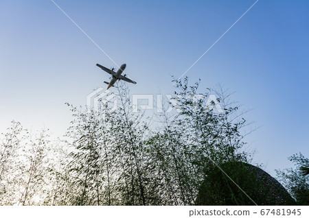 Sunny view of an airplane fly by Sunny view of an airplane fly by 67481945