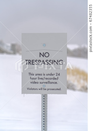 No Trespassing sign against a snowy landscape No Trespassing sign against a snowy landscape 67482355