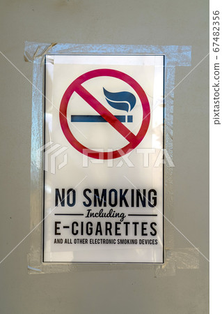 No Smoking sign taped on a gray surface No Smoking sign taped on a gray surface 67482356
