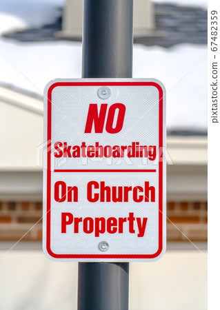 No Skateboarding On Chrurch Property sign on pole No Skateboarding On Chrurch Property sign on pole 67482359