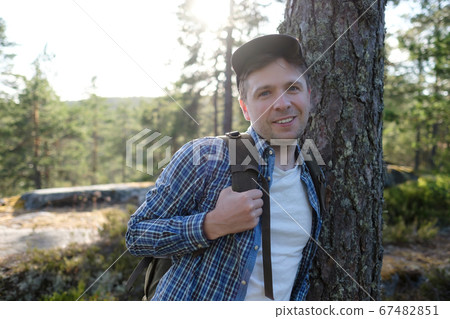 Handsome man walking outdoors at forest, enjoying his vacation. 67482851