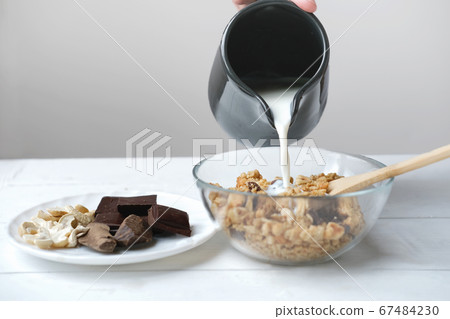 homemade granola with chocolate and nuts. granola in a bowl homemade granola with chocolate and nuts. granola in a bowl 67484230