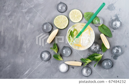 cool fresh mojito on grey background. cool fresh mojito on grey background. 67484232