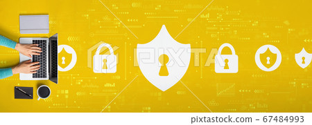 Cyber security theme with person using a laptop 67484993