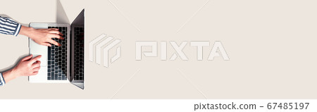 Person using a laptop computer 67485197