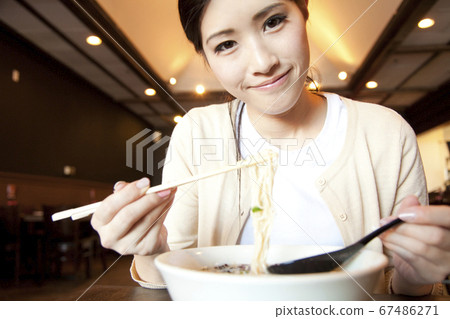 Female customer eating ramen Female customer eating ramen 67486271