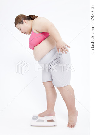 A metabolic syndrome woman riding a scale A metabolic syndrome woman riding a scale 67489133